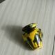 Small ceramic vase, yellow and green colors, artistic design,