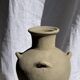 Light beige-grey Indonesian terracotta vase with 4 small handles and a high neck.