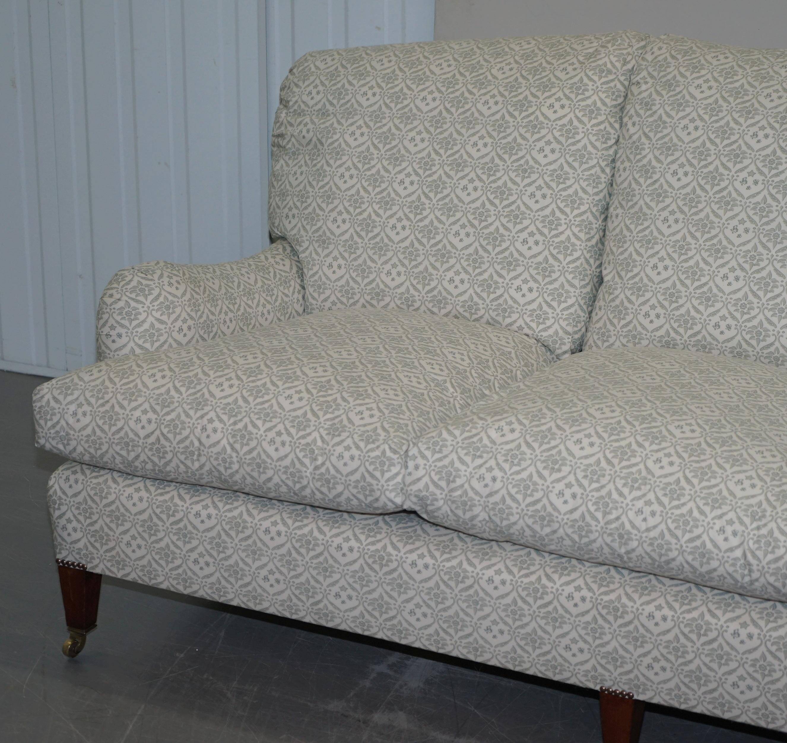 Howard & Sons canapé with feather cushions and ticking fabric, Victorian style.