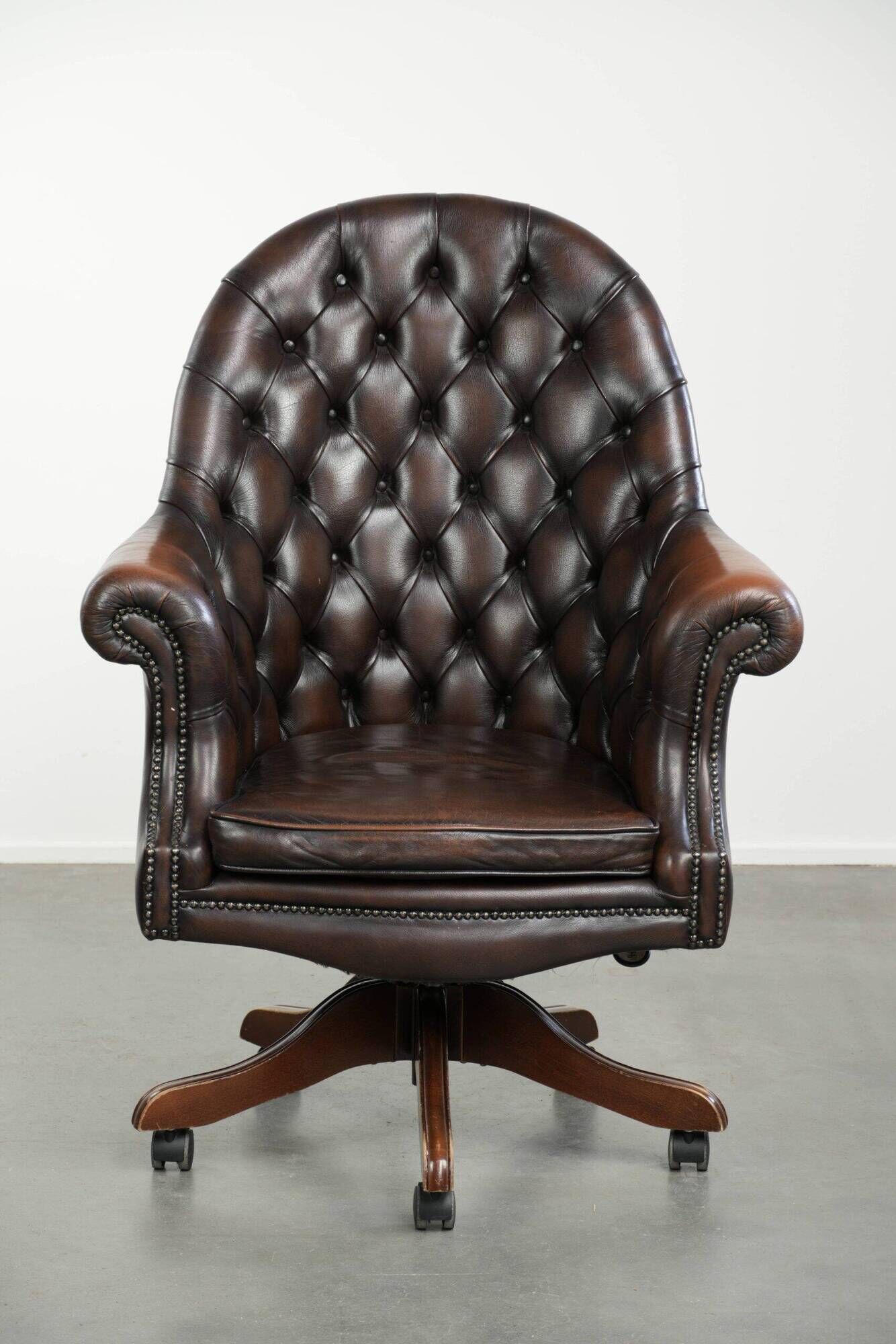Brown cow leather Chesterfield office chair on wheels in English style