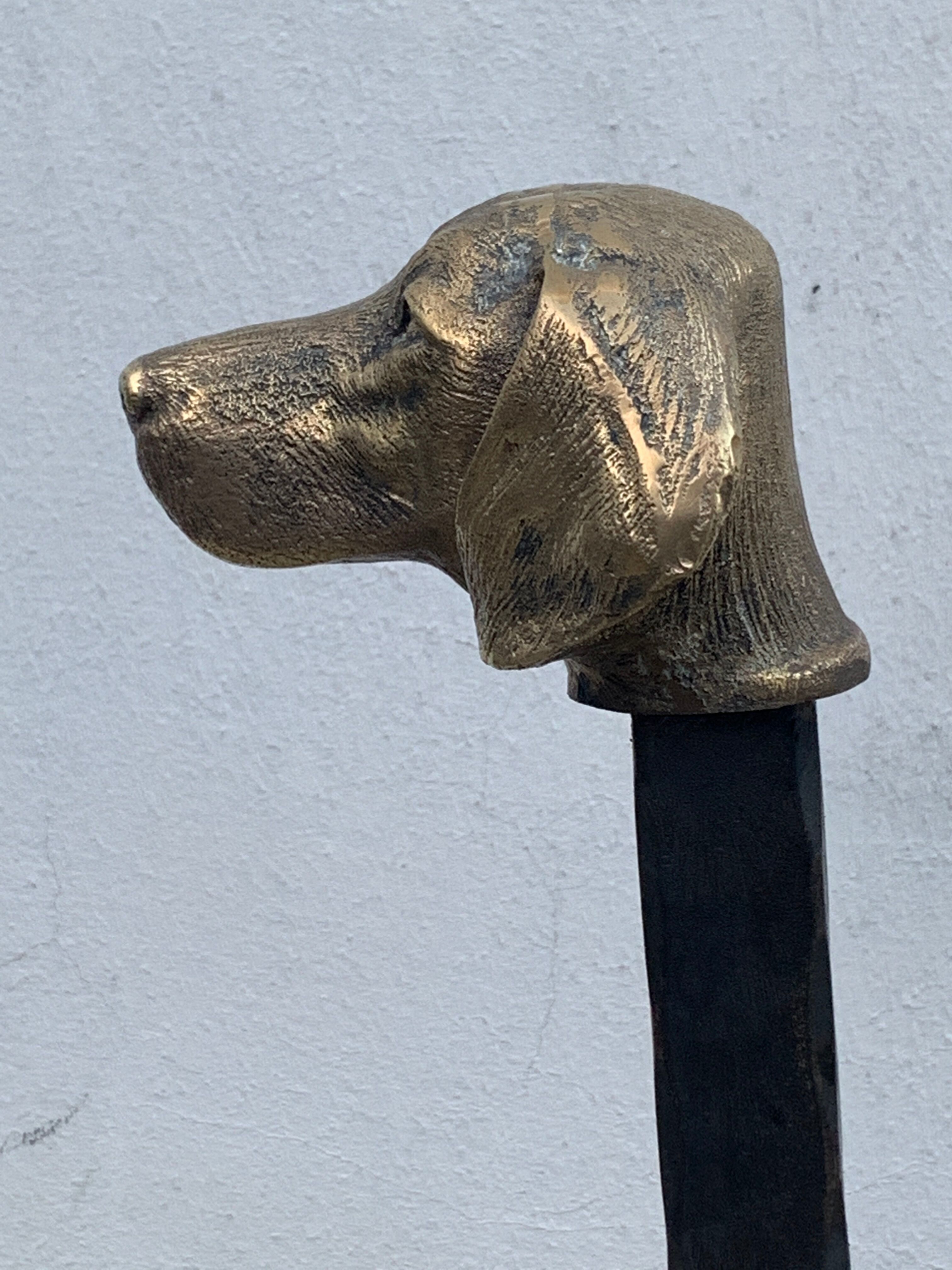 Pair of metal chenets decorated with brass dog heads