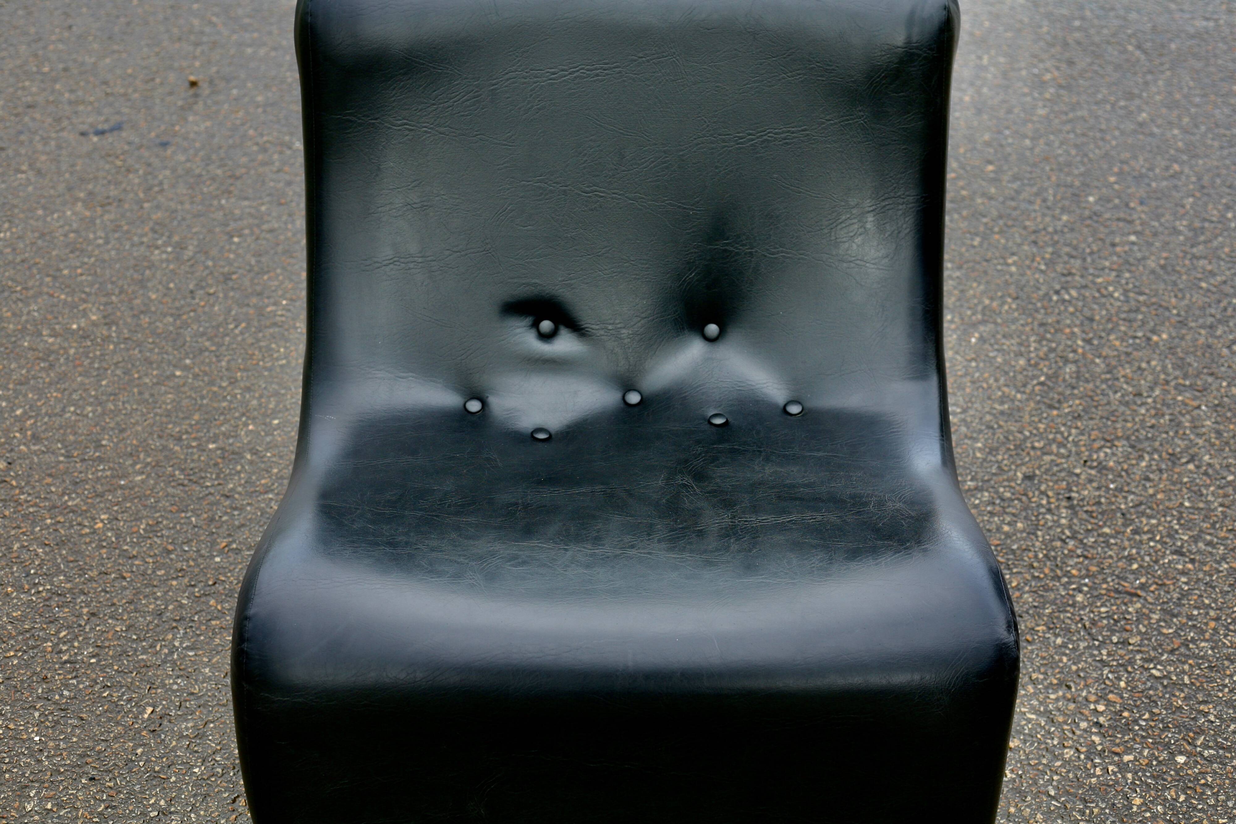 Pair of “space age” low chairs. Black faux leather. Circa 1970