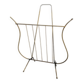 Golden metal lyre magazine rack from the 1950s.