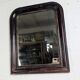 Antique Louis Philippe mirror with a patinated black frame.