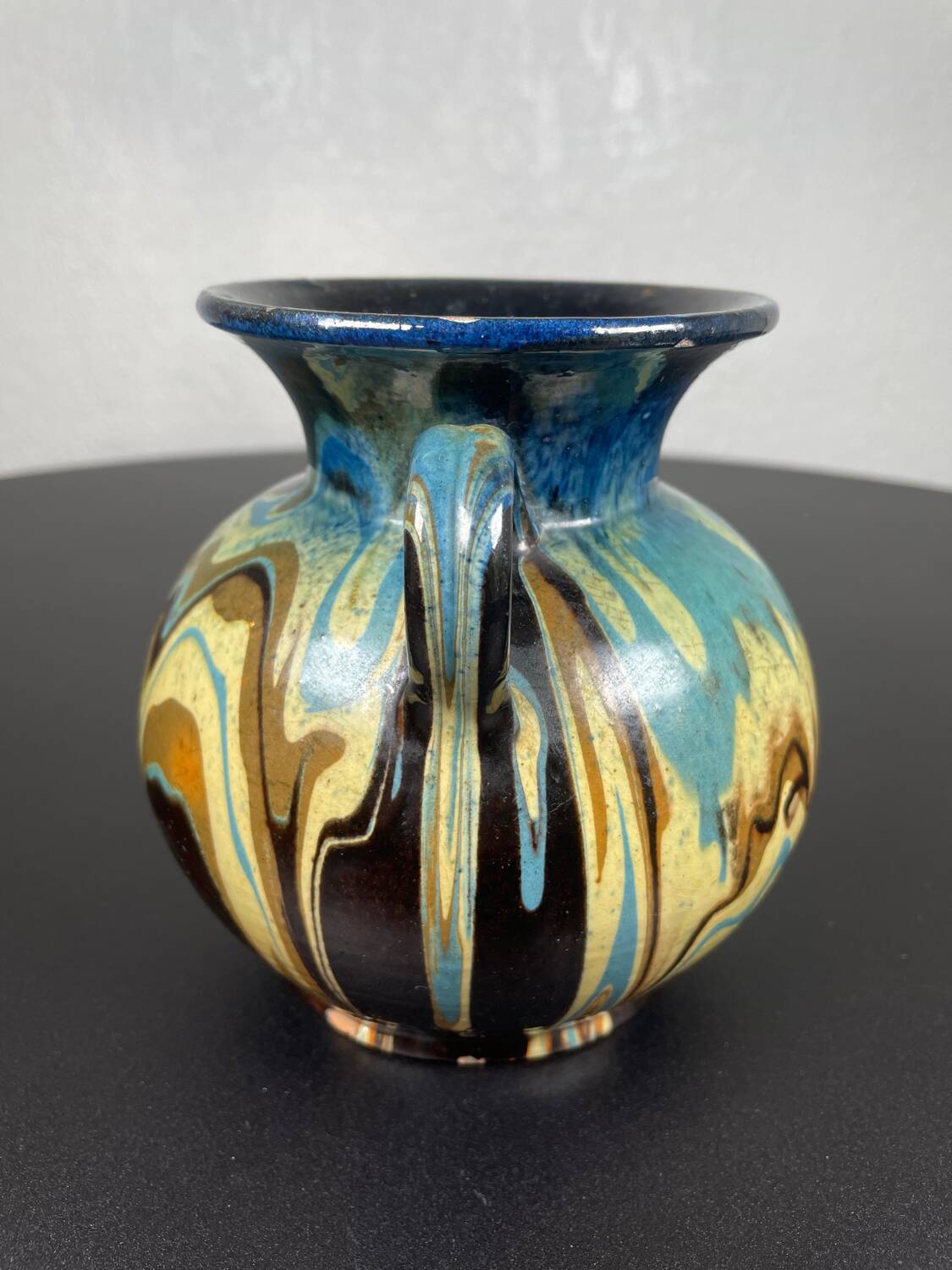 Black ball vase with handle, yellow blue marbled