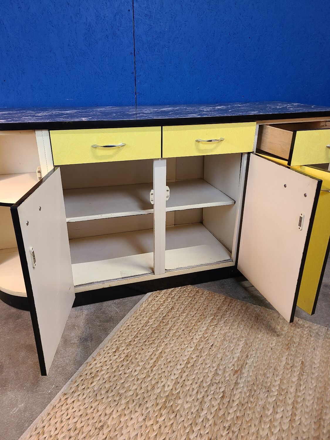 Vintage yellow sideboard, and black marble top.