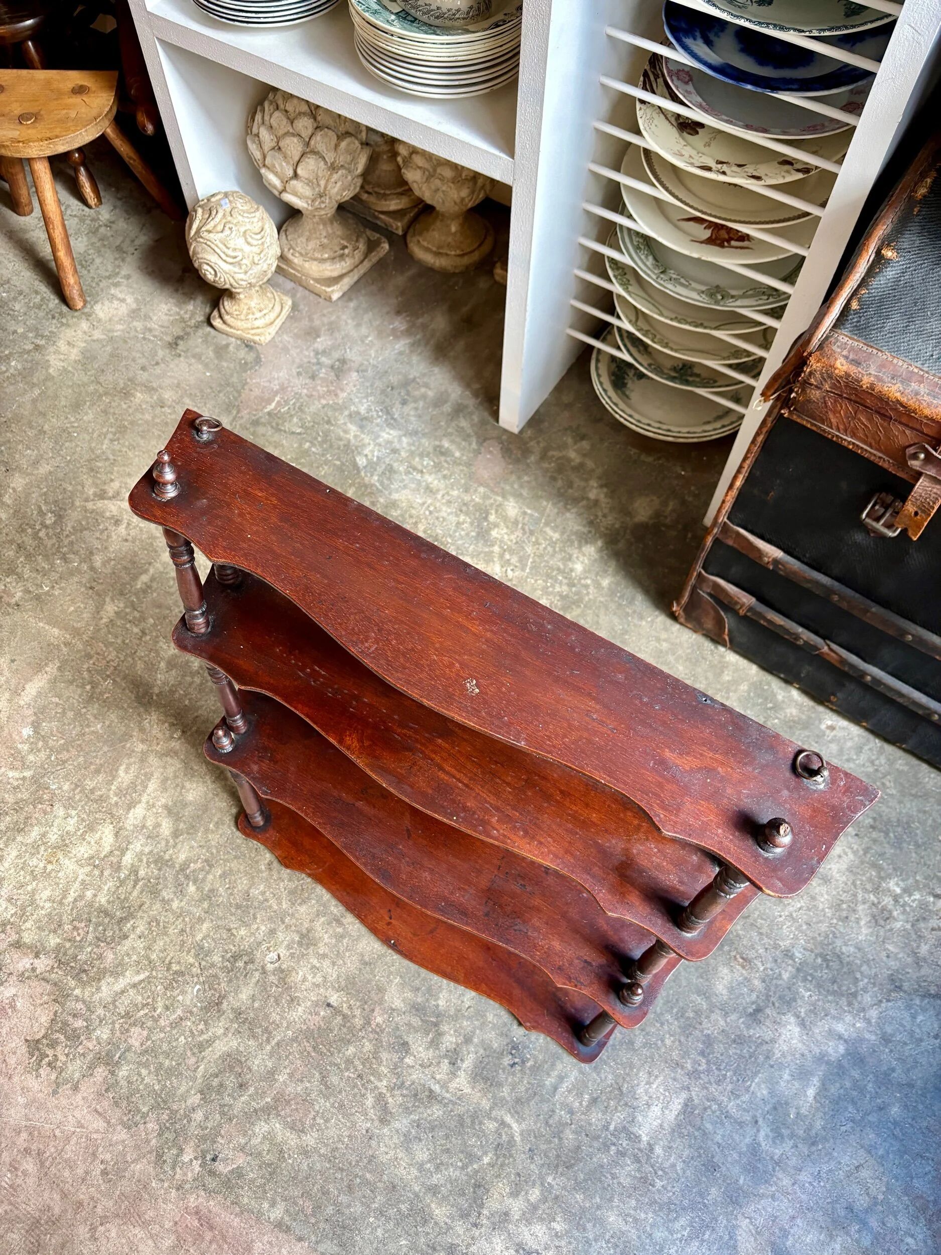 Curved and turned wooden wall shelf