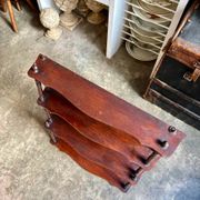 Curved and turned wooden wall shelf