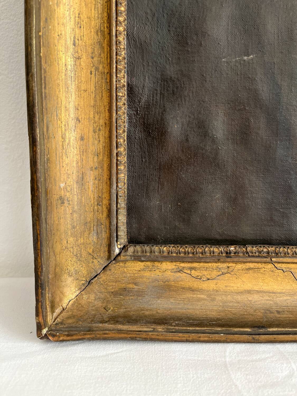 Old oil painting on canvas portrait of a woman with a red bow, late 19th century