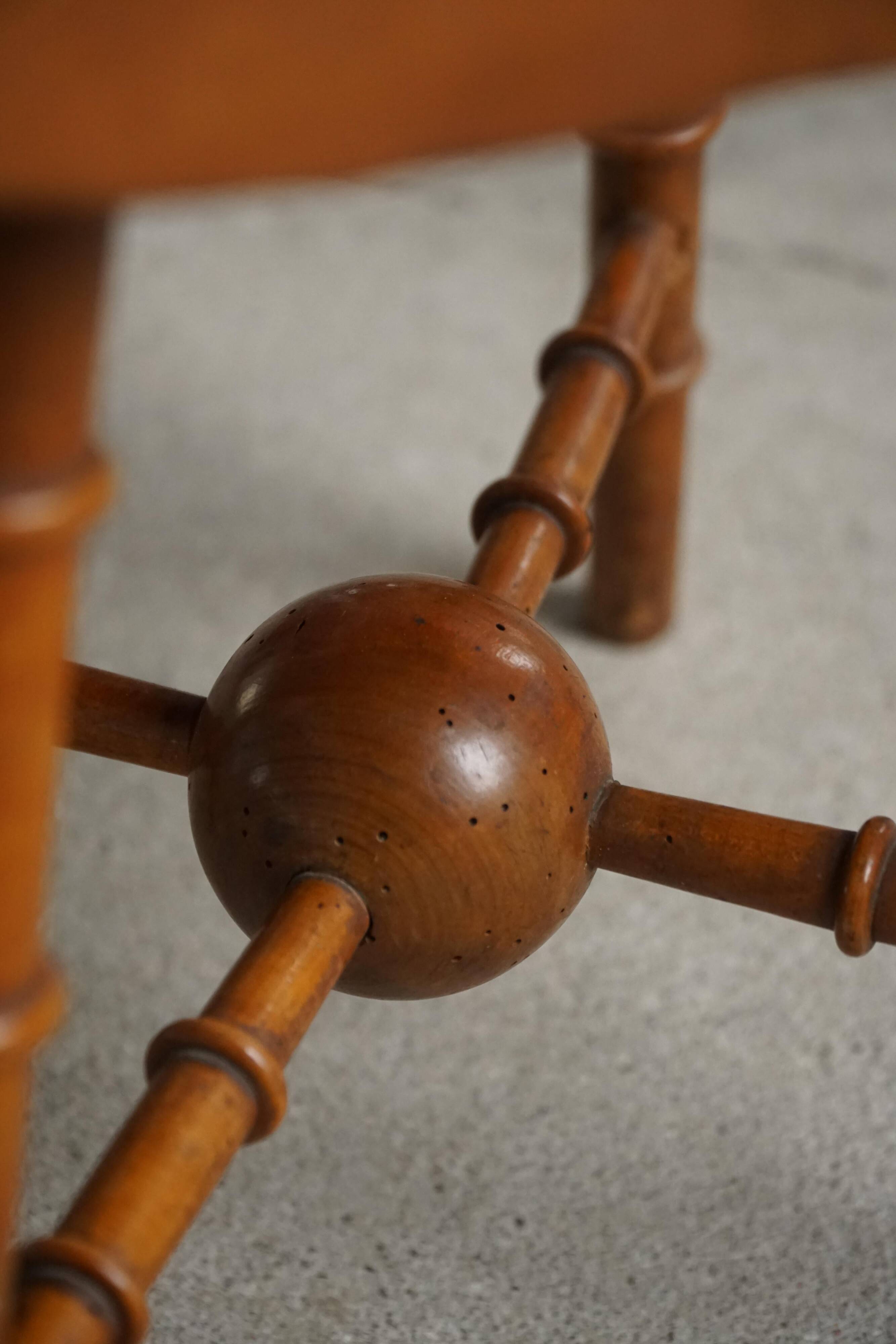 Turned wooden stool with leather seat, mid-20th century, Danish modern.