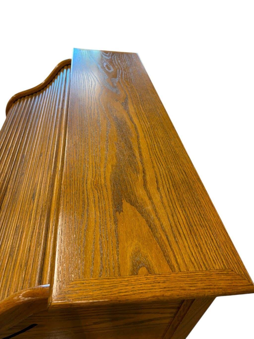 Vintage American wooden desk with a roll-top.