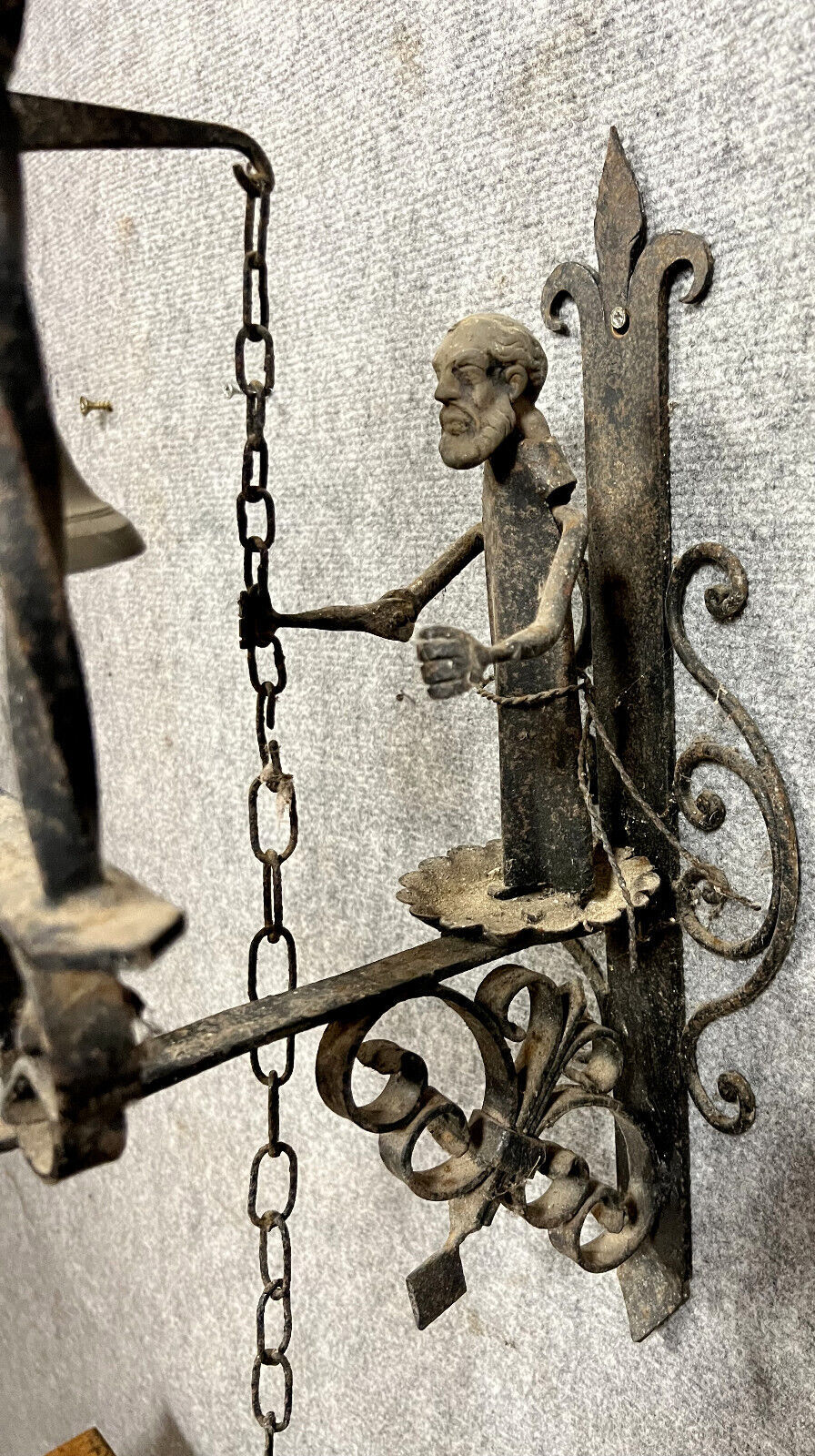 Wrought iron entrance bell depicting a monk ringing a bell circa 1900-1930