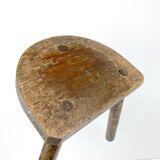 Ancient tripod milking stool - field theme, nature