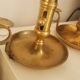 Many candlesticks and a small oil lamp.