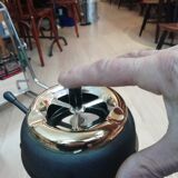 Ashtray with mechanism on foot