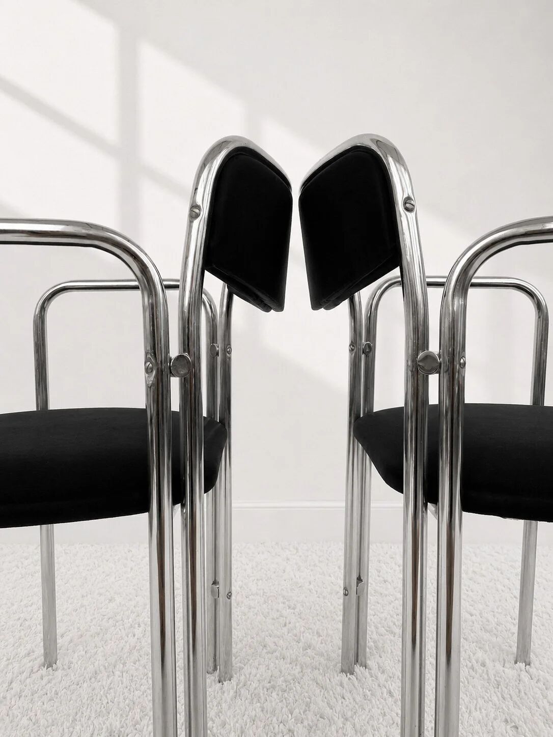 Vintage chairs with double chrome structure and black velvet. 70s