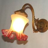 French Art Nouveau wall sconce in bronze with a white and pink glass shade.
