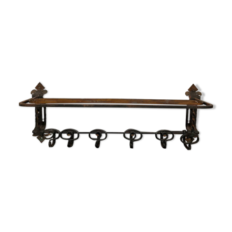 Large antique wall-mounted coat rack in wrought iron