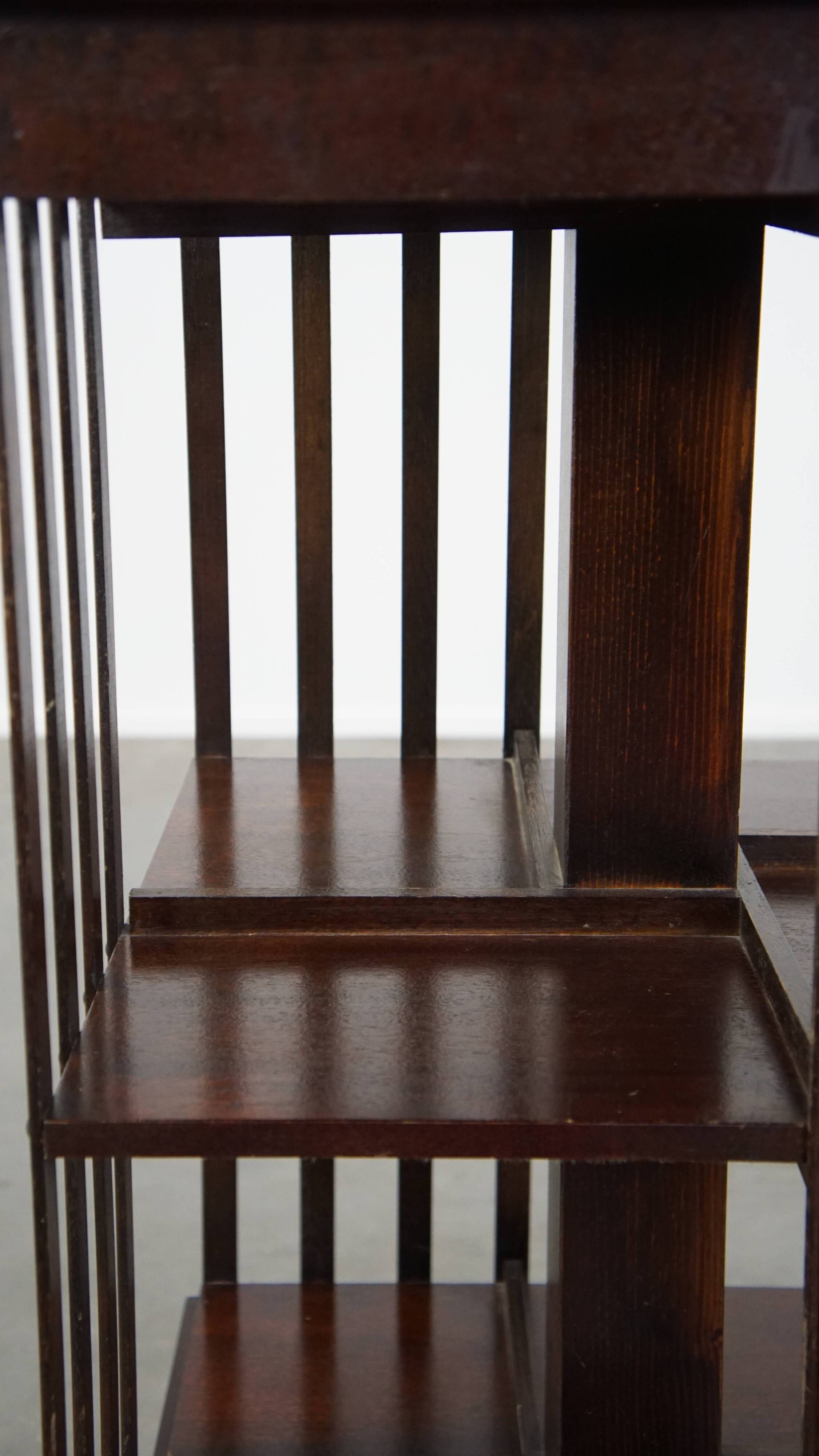 Wooden bookstand with green leather surface and on wheels in English style