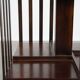 Wooden bookstand with green leather surface and on wheels in English style