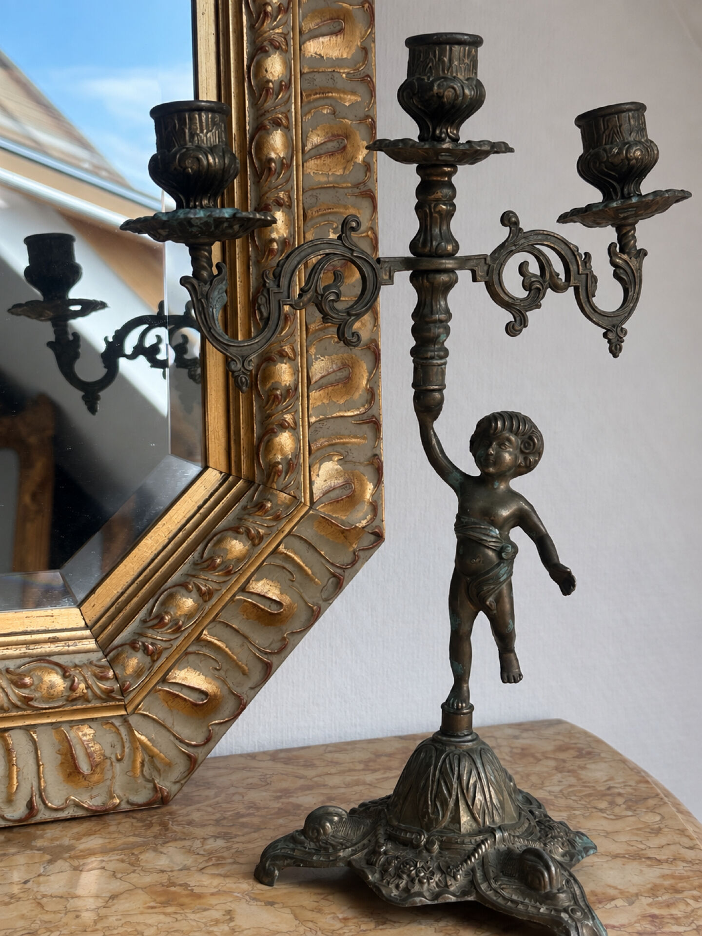 Set of 3 antique three-branch candelabras with cherubs and bronze patina.