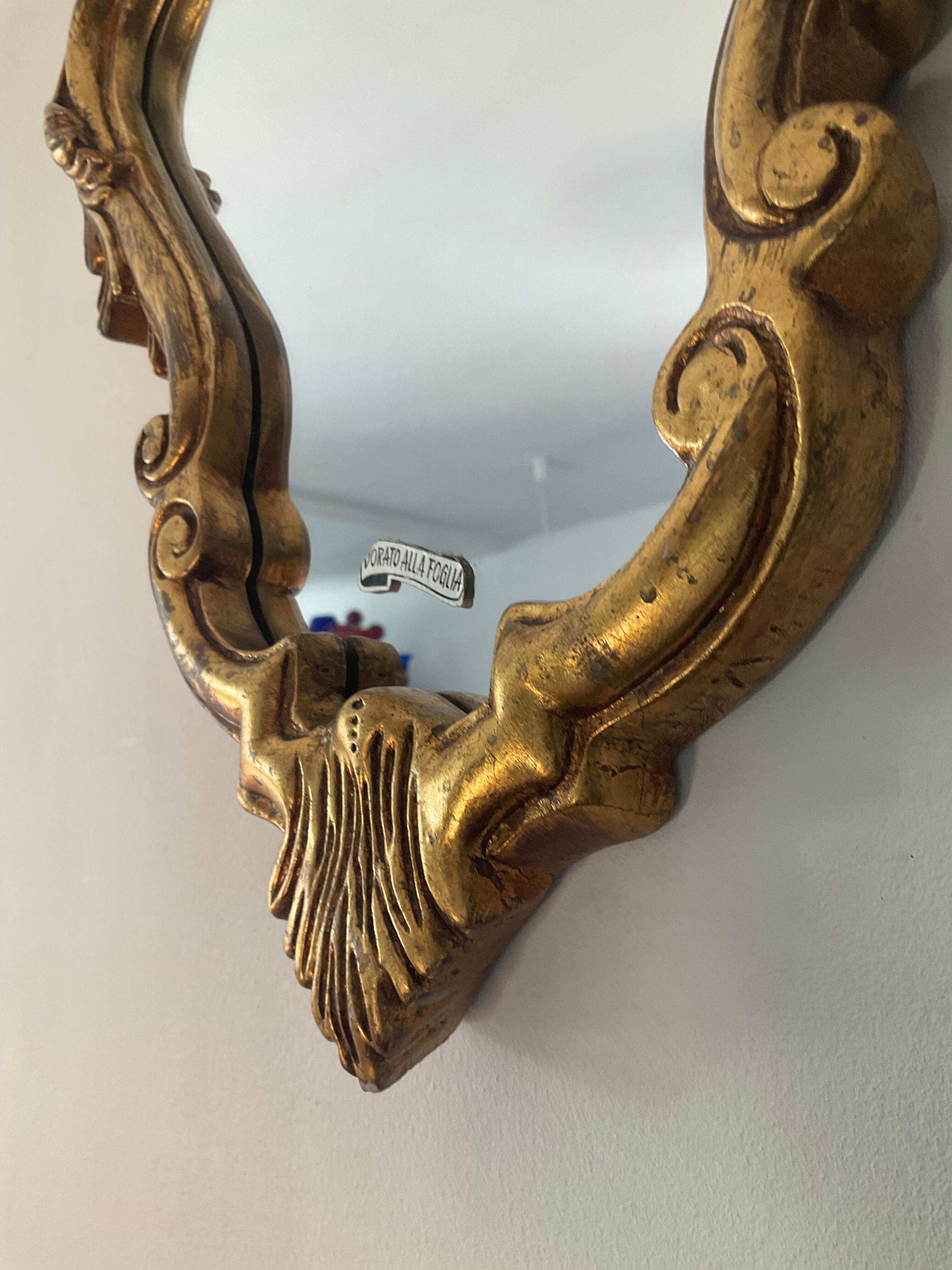 Old italian mirror in gilded plaster with leaf