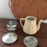 Old tea pot or coffee maker in faience cream with filter.