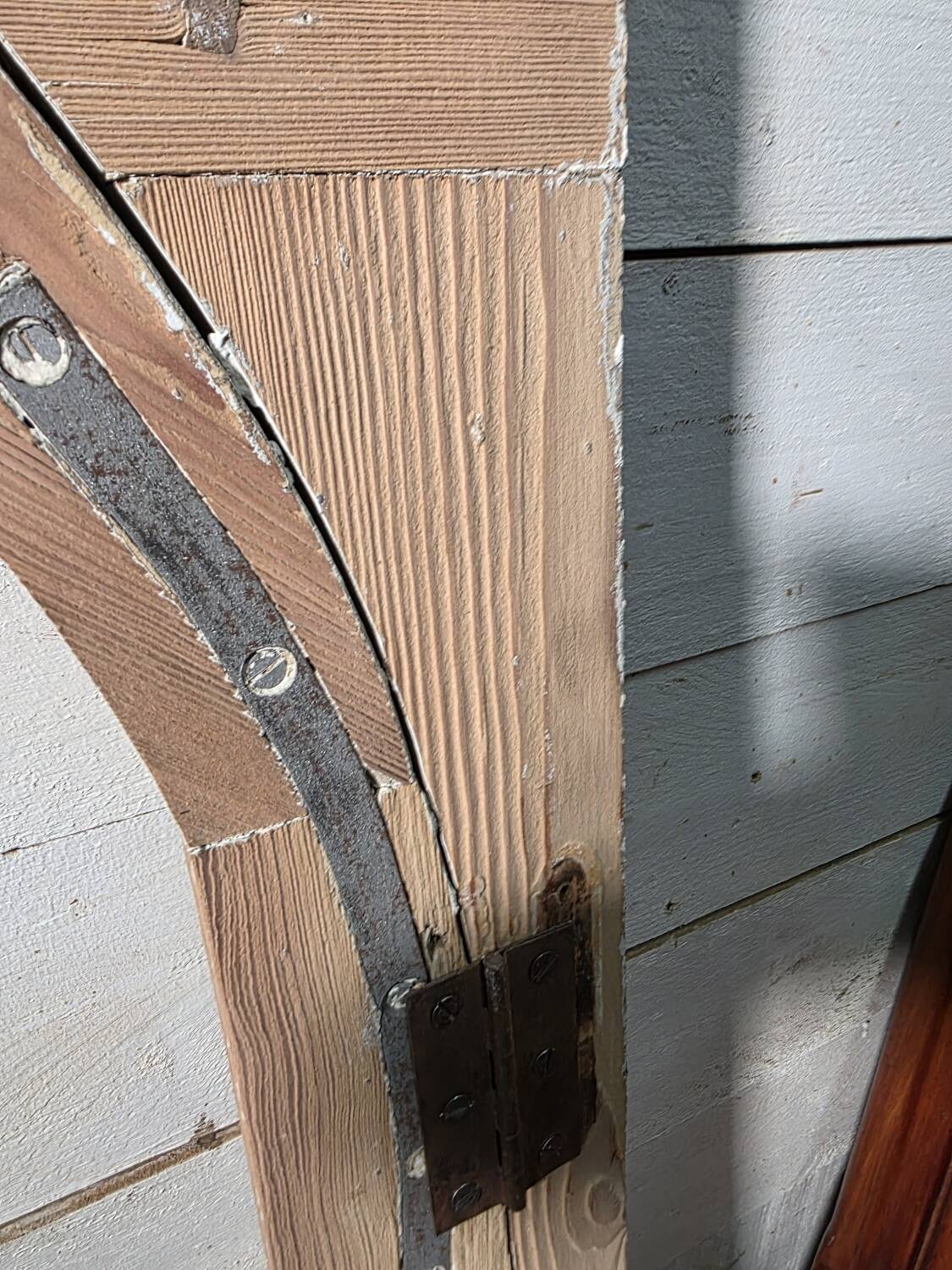 Old arched window made of fir wood