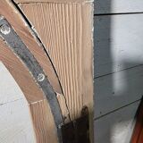Old arched window made of fir wood