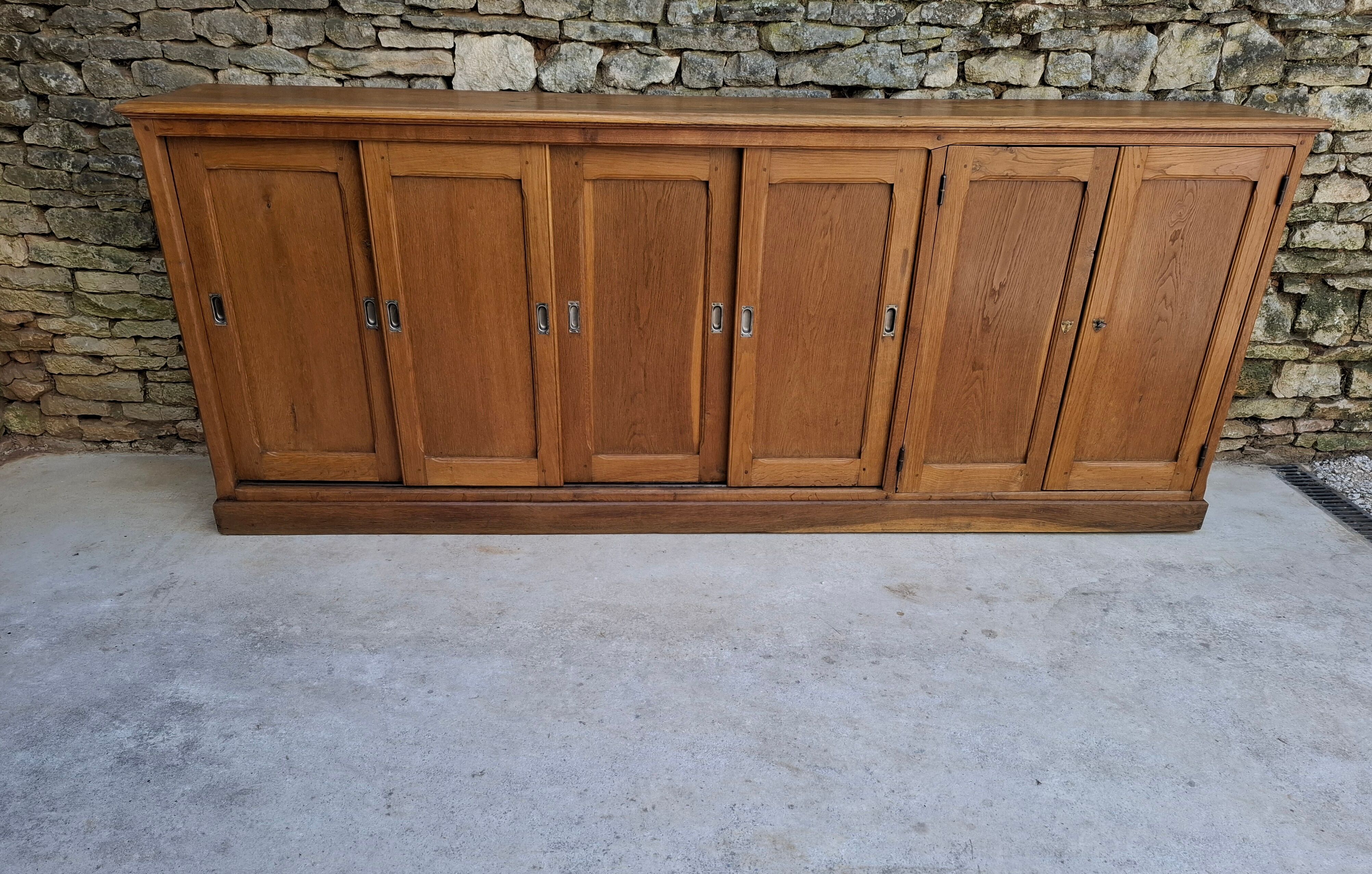 Oak workshop furniture with sliding doors.