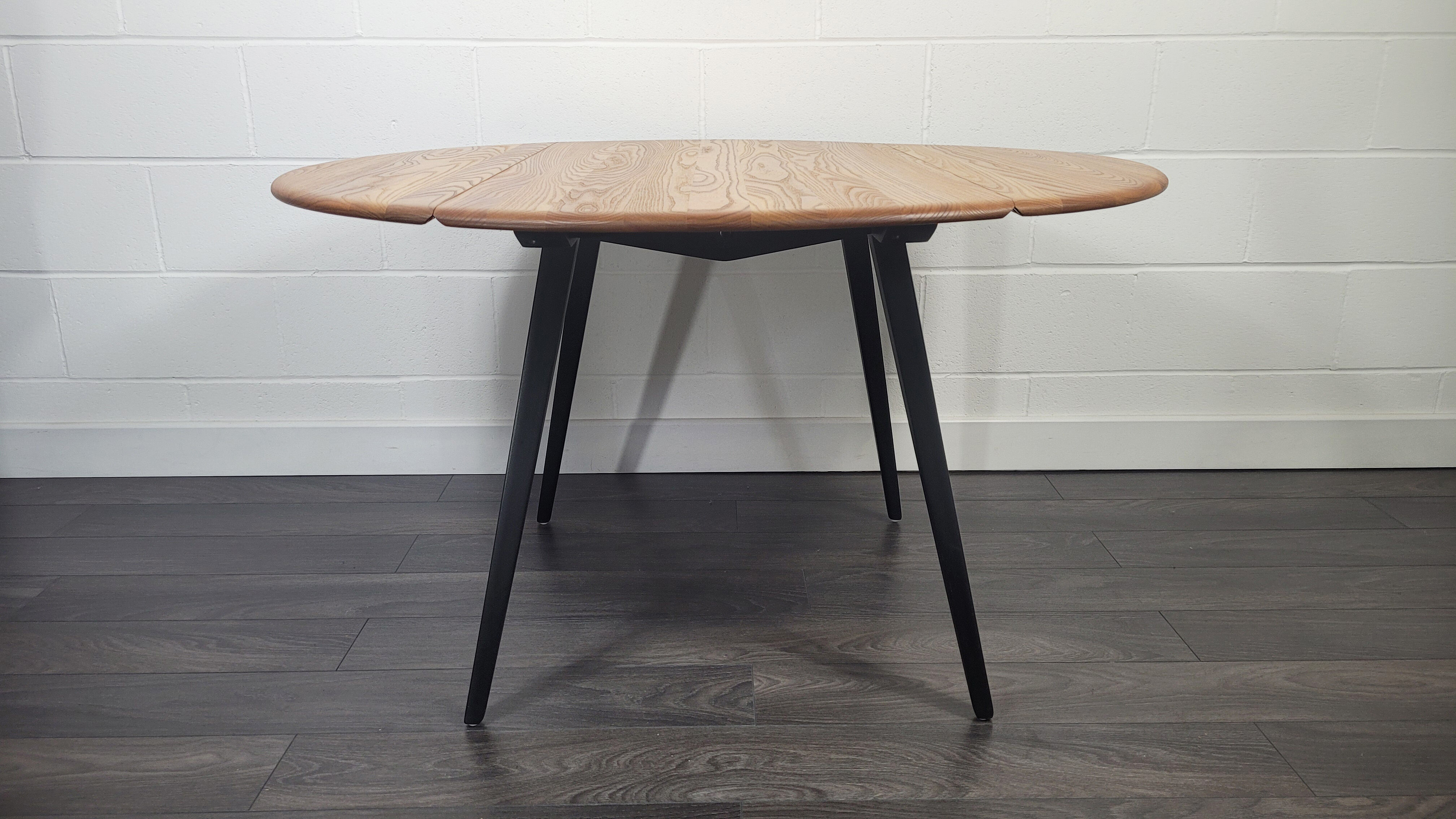 Ercol round drop leaf dining table - black leg, 1960