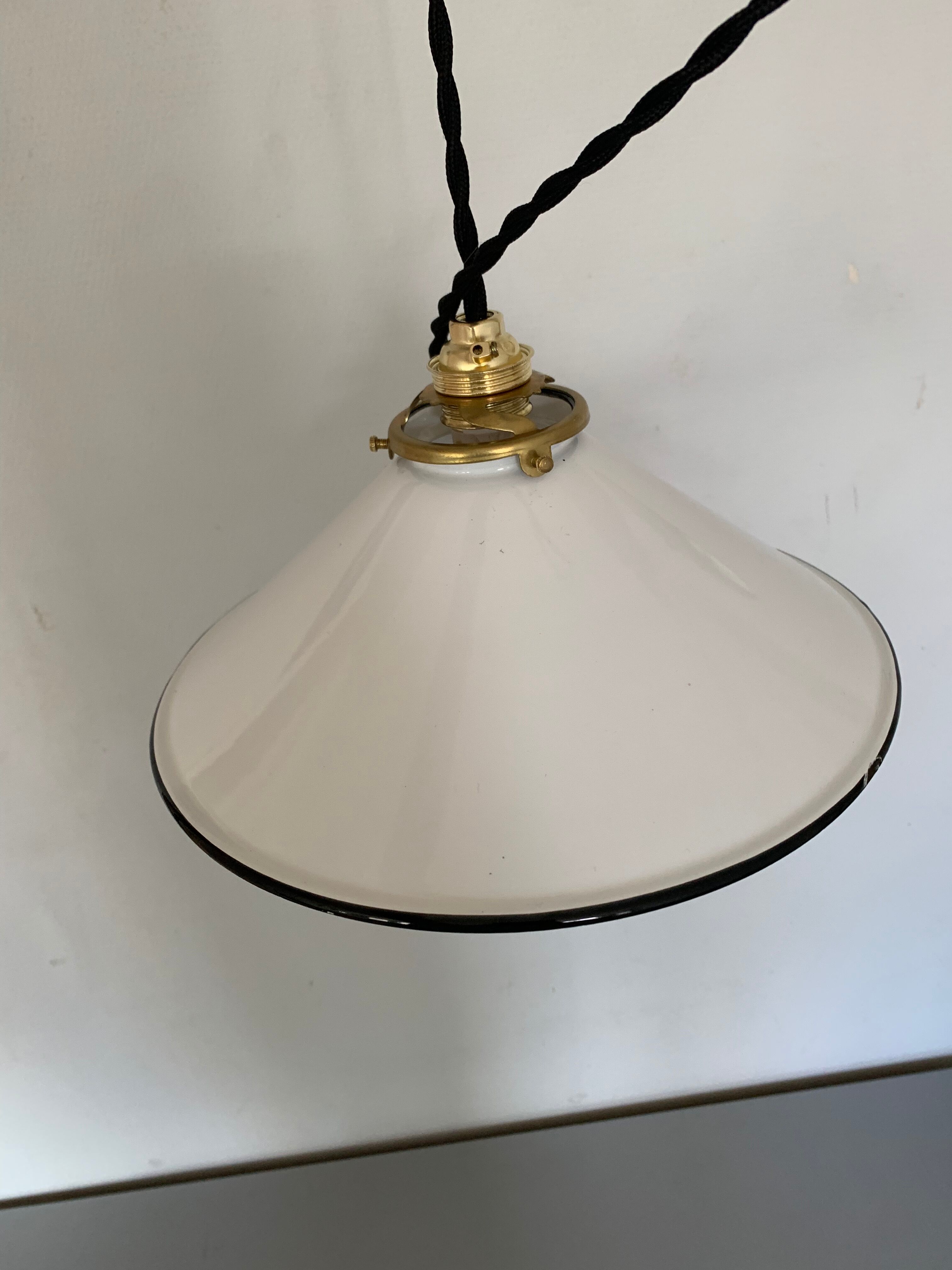 Old pair of white industrial metal suspensions with black border