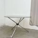 Round dining table in chrome and smoked glass.
