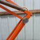 Luxo L4 vintage orange lamp with foot