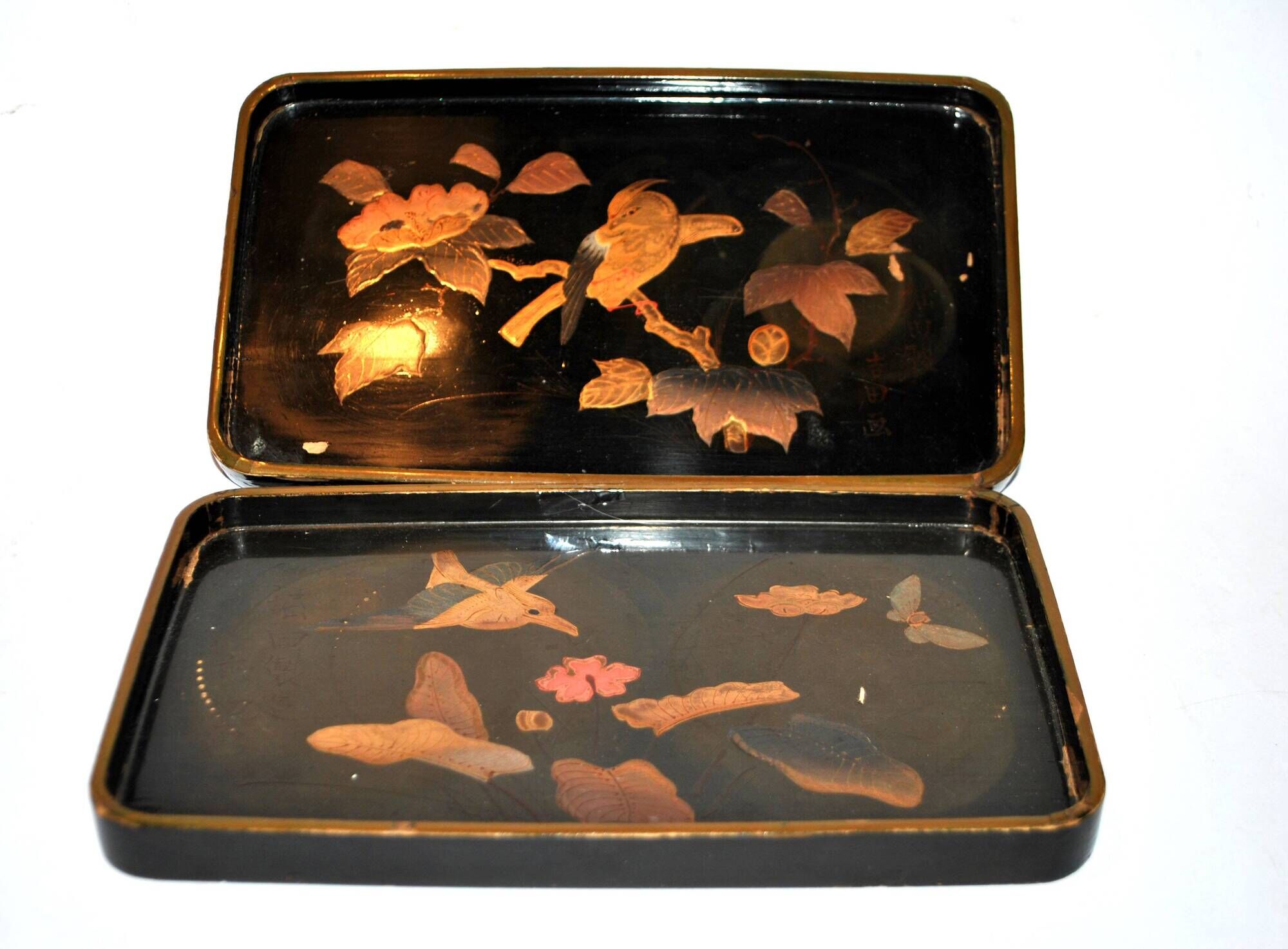 Set of two brown and black Chinese lacquer trays with bird decor