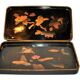 Set of two brown and black Chinese lacquer trays with bird decor