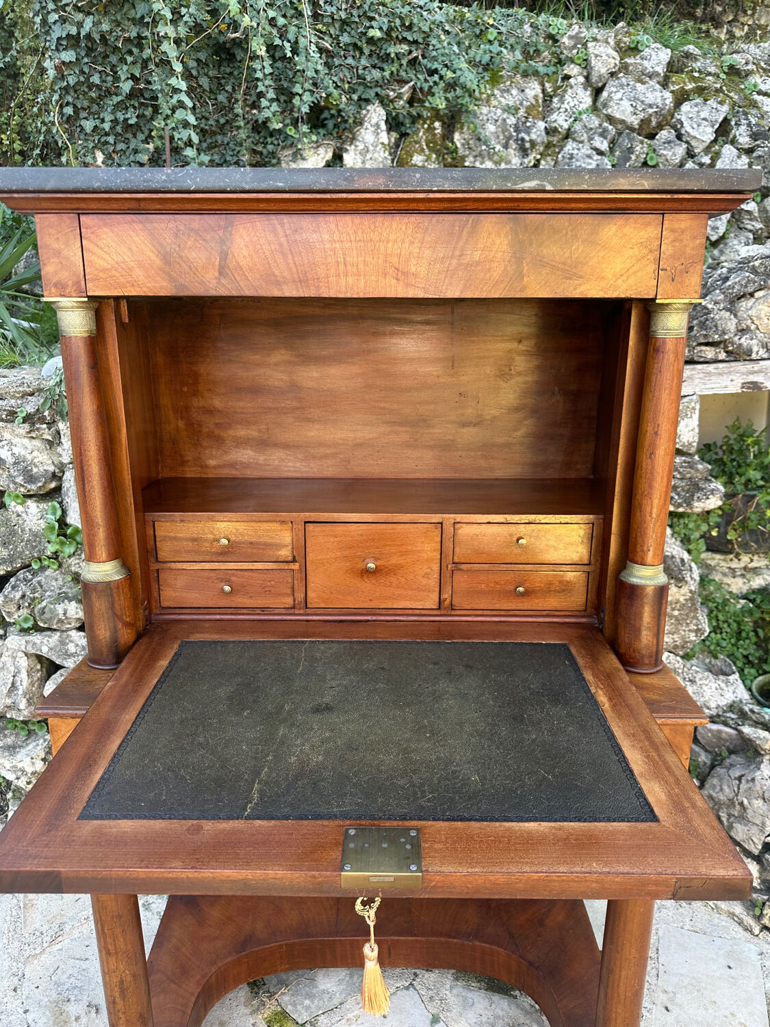 A small piece of Bonheur du jour with detached columns in Empire-era mahogany.