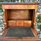 A small piece of Bonheur du jour with detached columns in Empire-era mahogany.