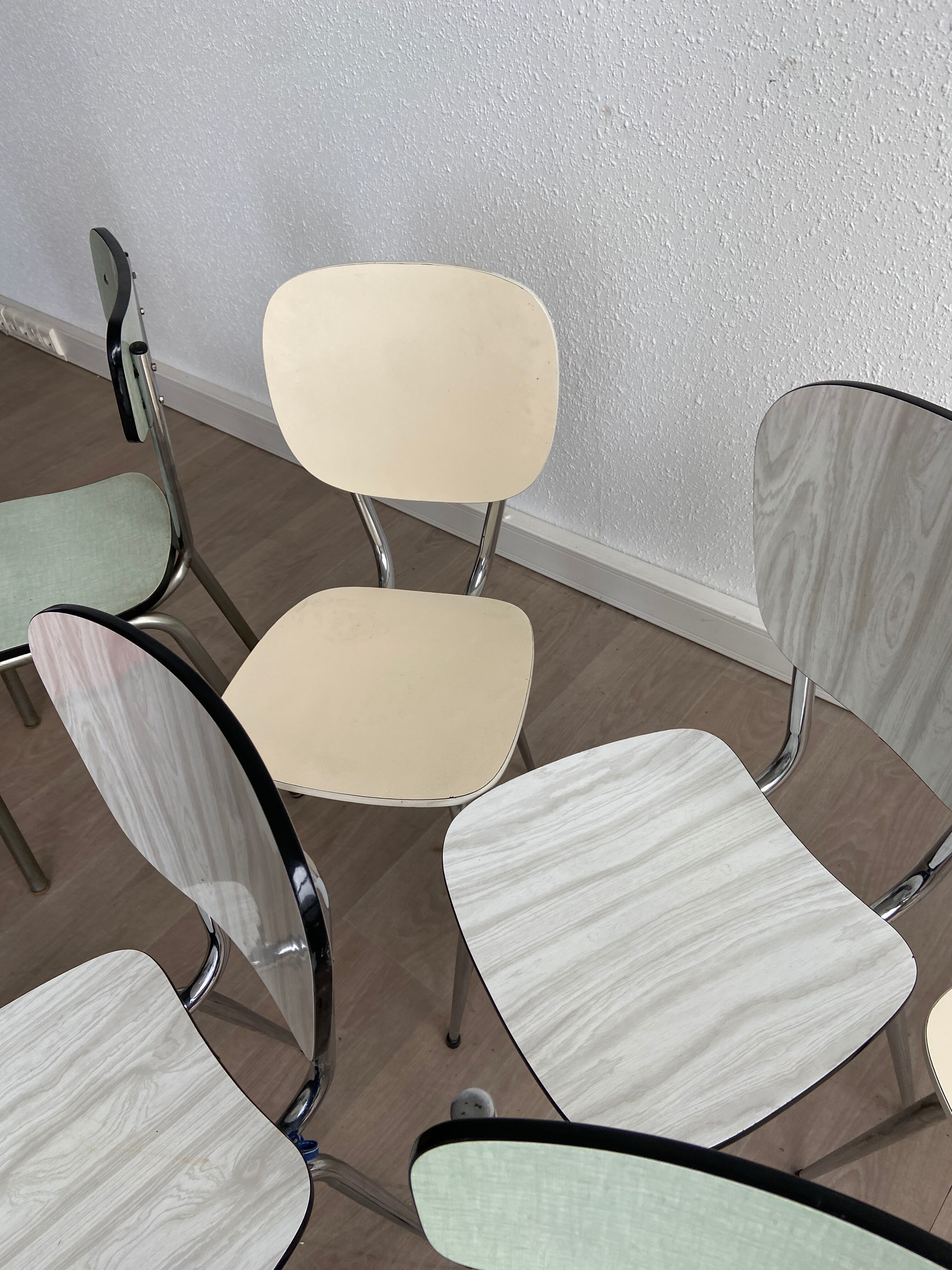10 mismatched multicolored Formica chairs 60s