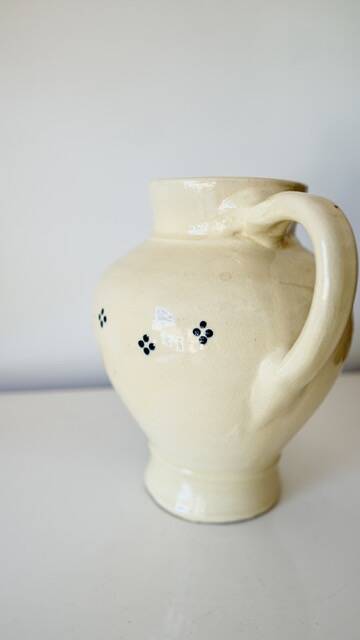 Vintage butter yellow ceramic pitcher in rustic style