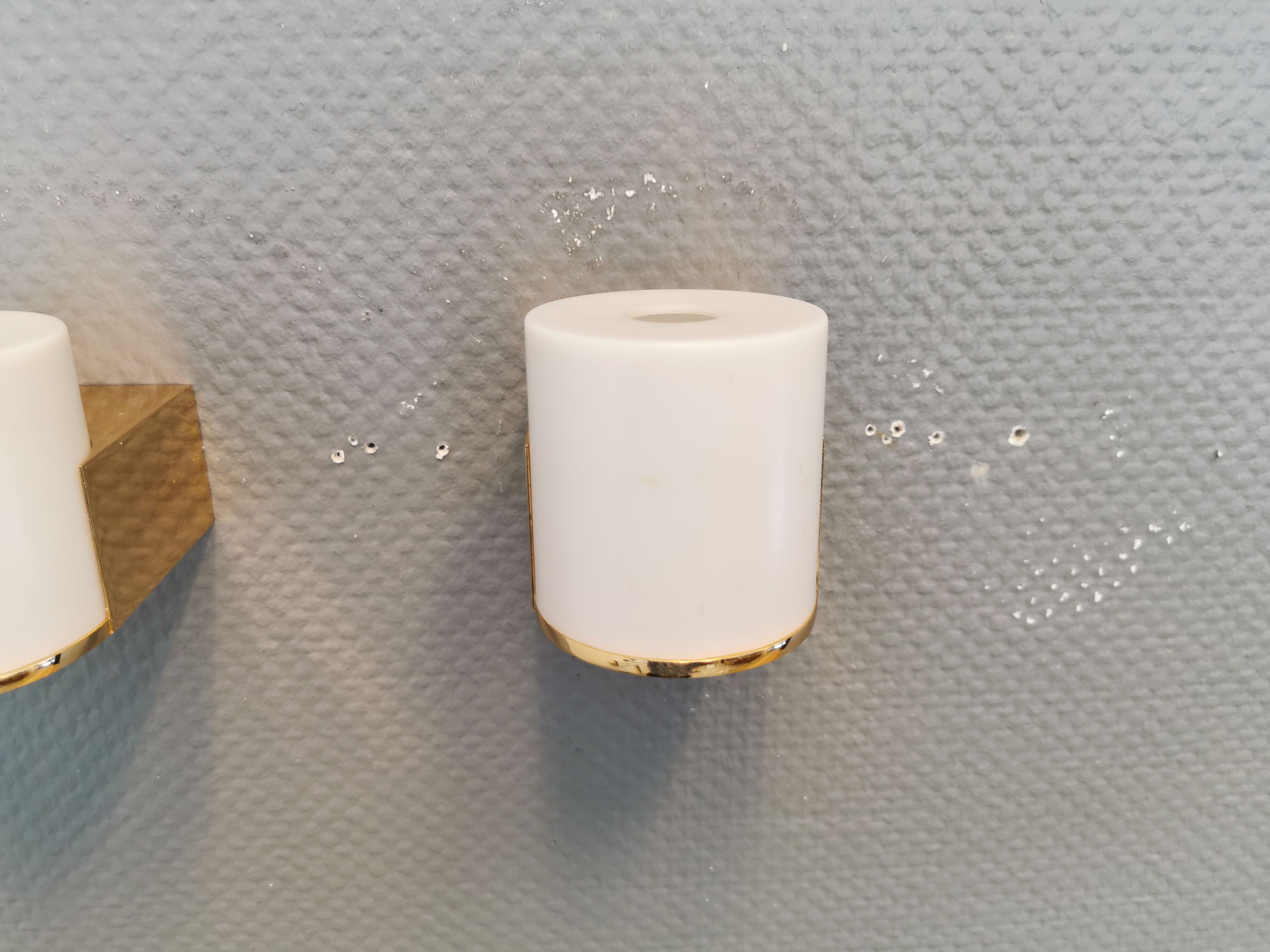 Wall lamps with milky white acrylic plastic shades and solid brass bases