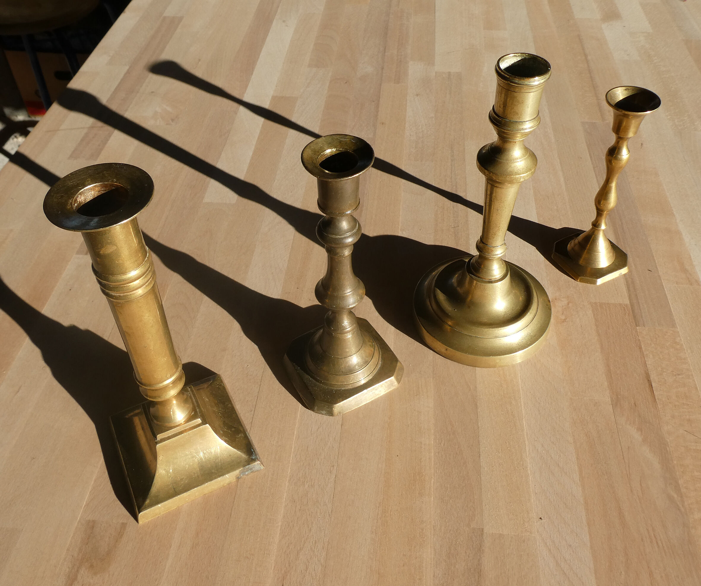 Set of 4 old candle holders in golden brass