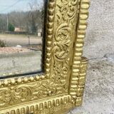19th-century antique mirror in carved gilded wood, Napoleon style.