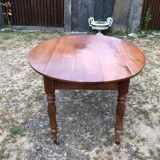 Louis Philippe oval shuttered table in solid cherry wood with 2 drawers.