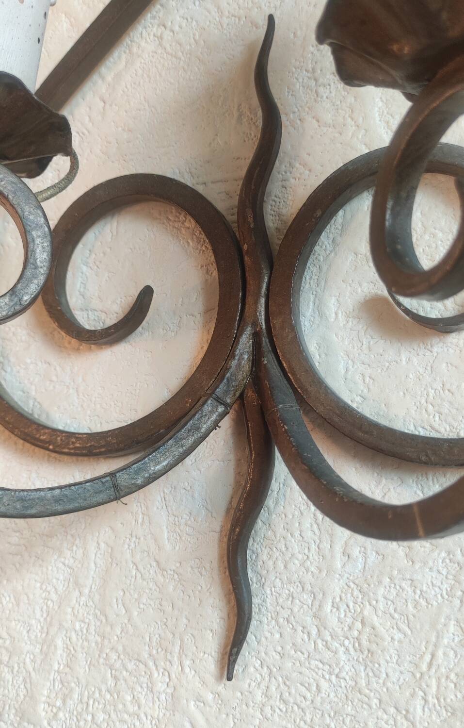 Old pair of wrought iron wall lights