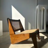 Reclined armchair in canned teak in natural wood