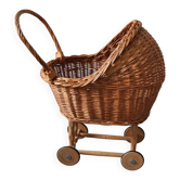 Brown wicker doll stroller on a wooden frame, wooden wheels — vintage (1890-1919)