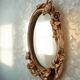 Oval wall mirror in Art Nouveau style with a decoration of birds and roses.