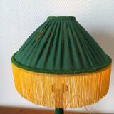 Green ceramic lamp with a vintage pleated fringe shade.