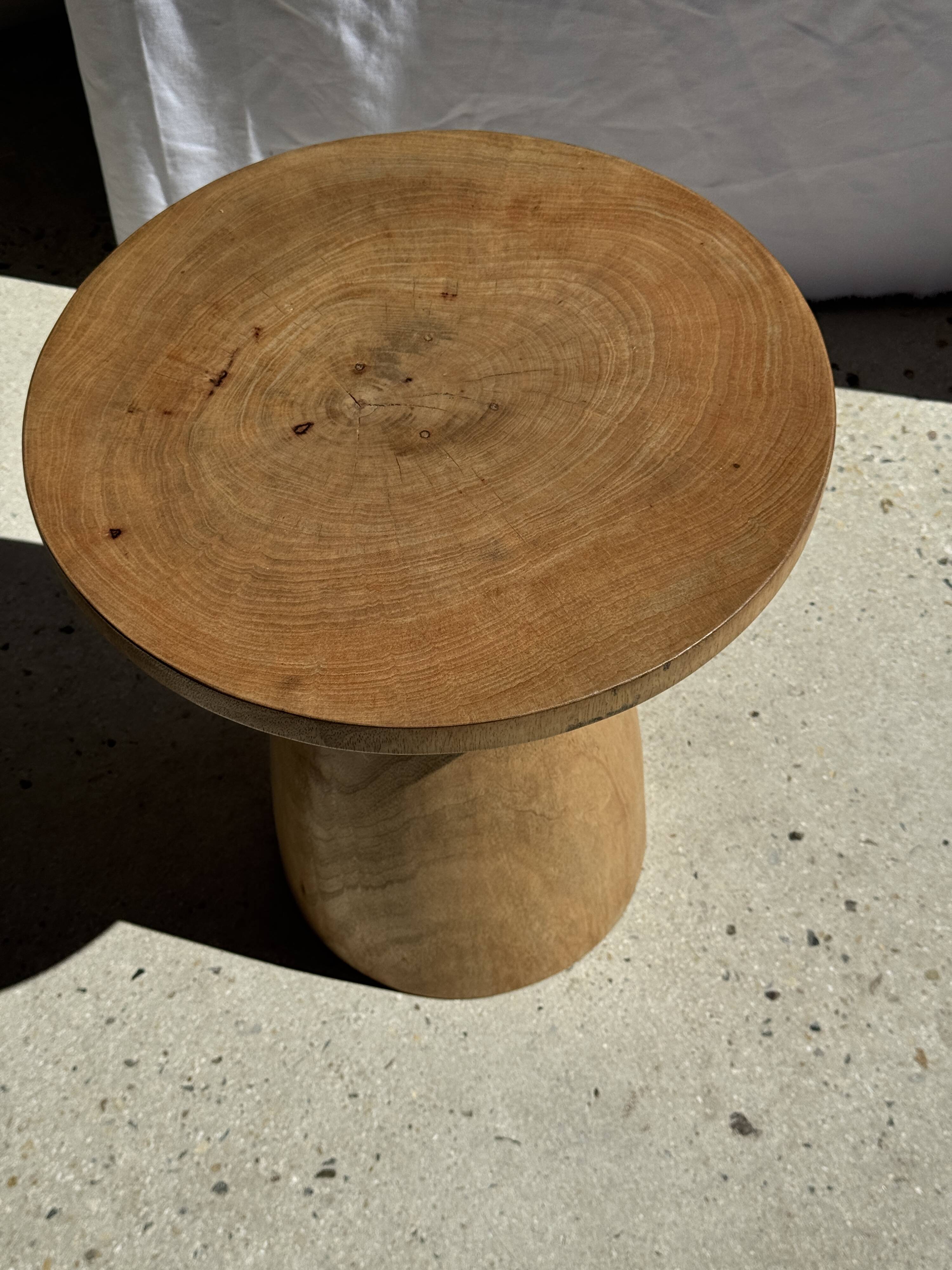 Natural solid mango side table (monoxyle) with conical legs.